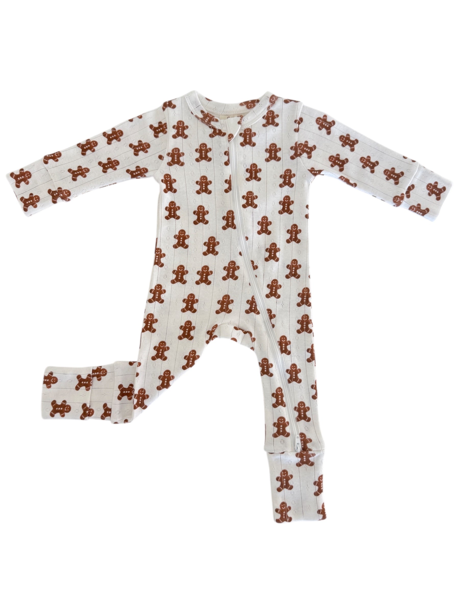 White baby onesie with gingerbread man patterns and long sleeves, featuring a front snap closure.