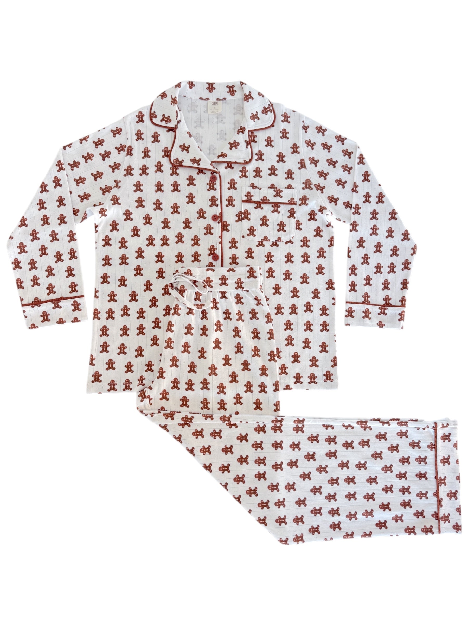 White pajama set with red gingerbread man pattern, featuring long sleeves and pants.