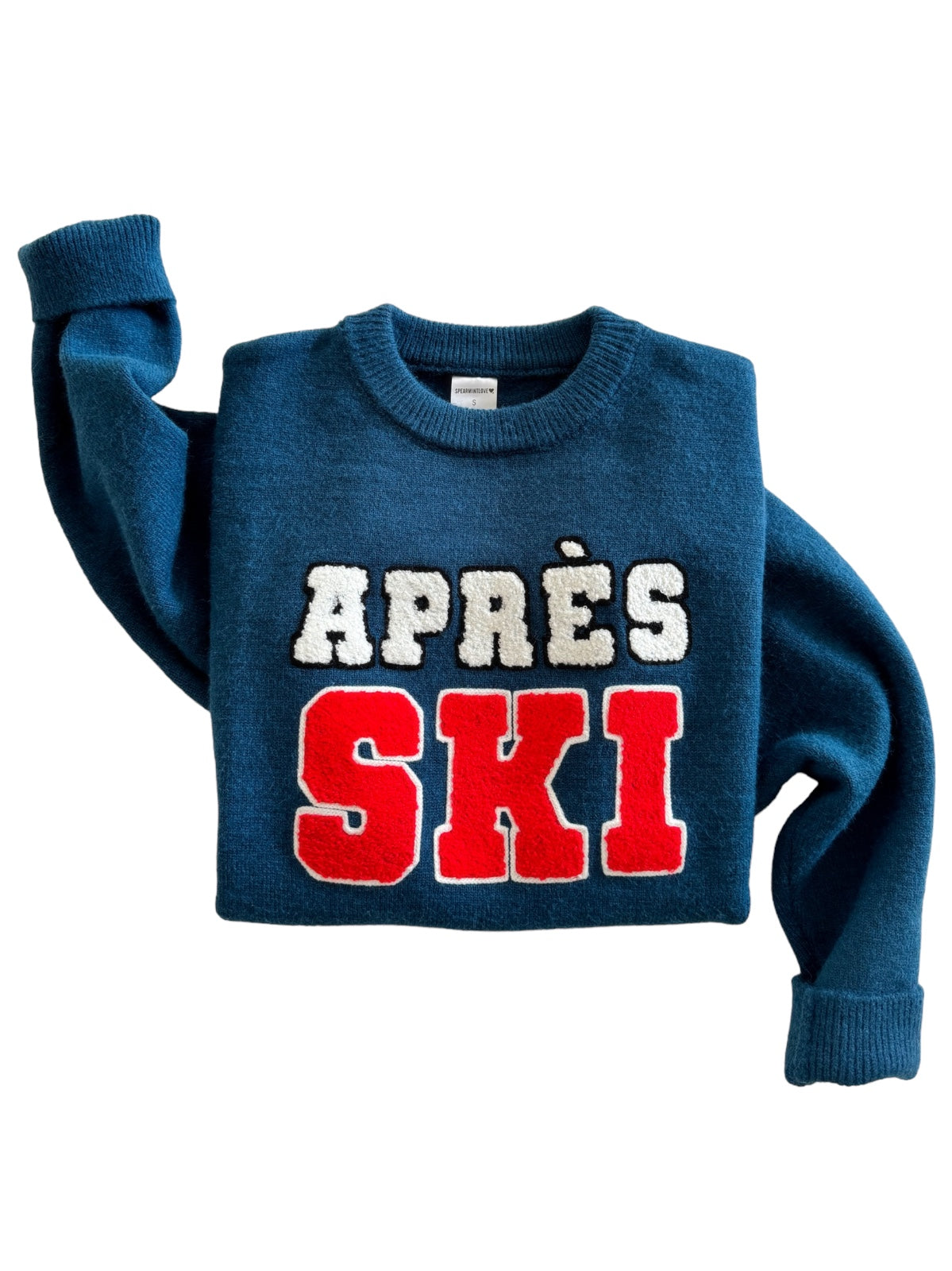 Blue sweater with "APRES SKI" in bold red and white letters. Cozy winter apparel for après-ski activities.