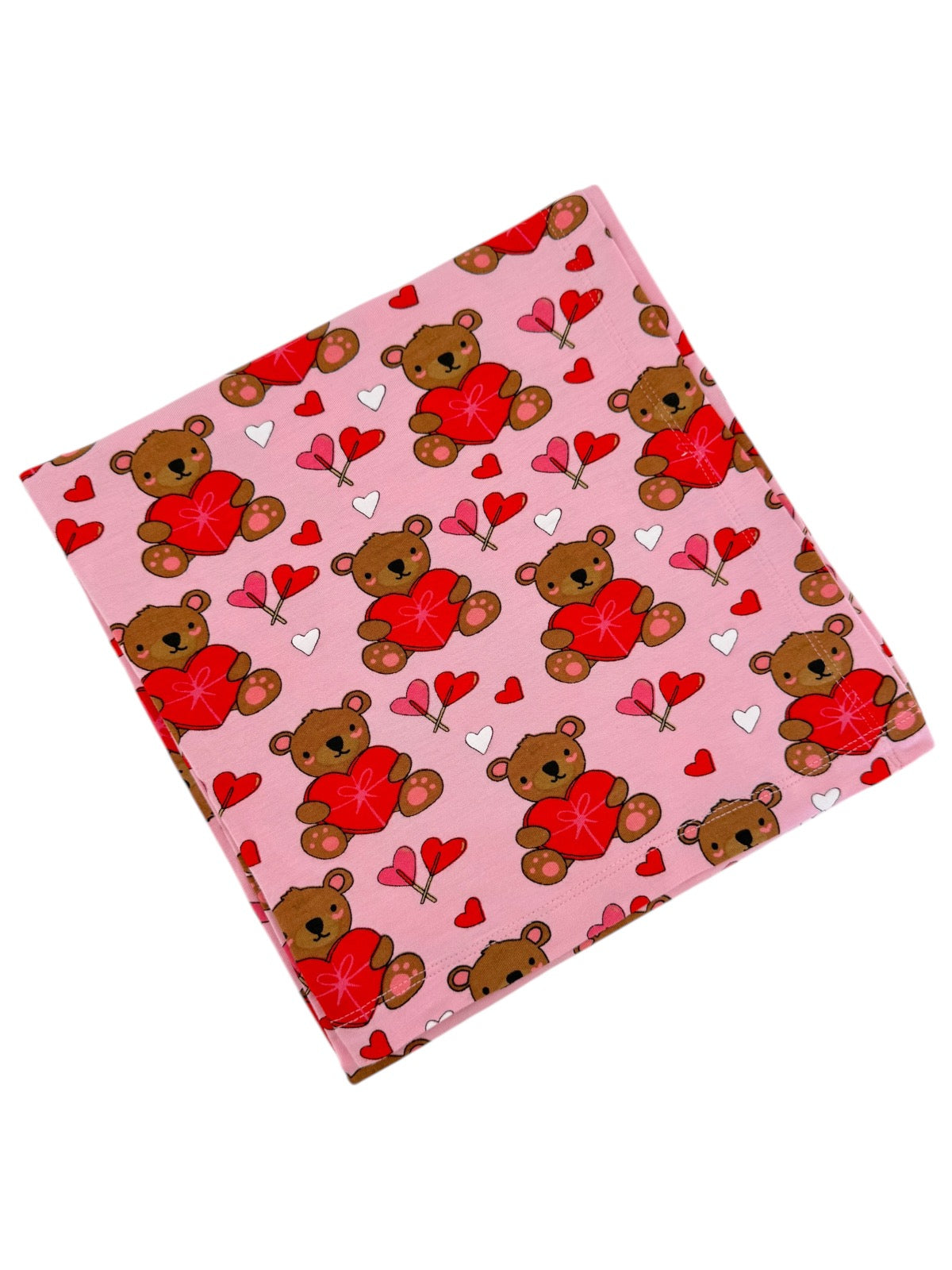 Pink fabric featuring cute teddy bears holding red hearts and small hearts, ideal for Valentine’s Day decor.