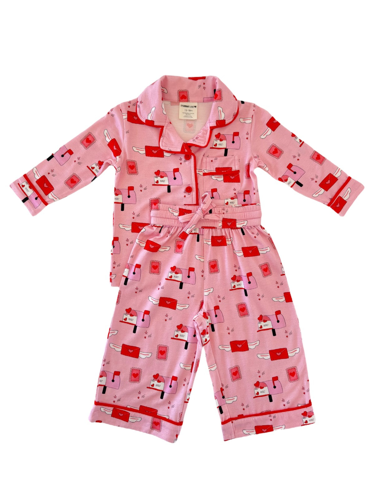 Pink children's pajamas featuring playful mailbox and heart patterns, with a collar and a tied waist.