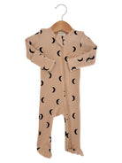 Tan baby onesie with black crescent moon patterns, displayed on a hanger against a white background.
