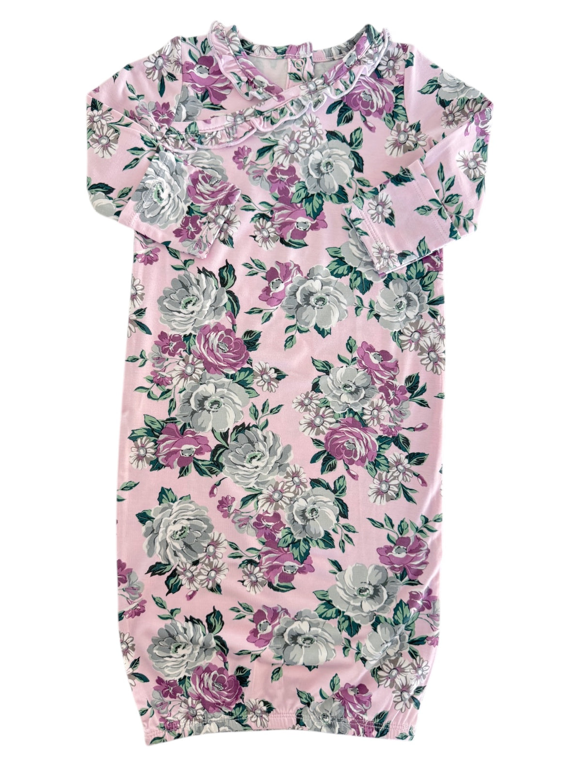 Floral dress in pink, featuring roses and greenery, with a ruffled neckline and short sleeves.
