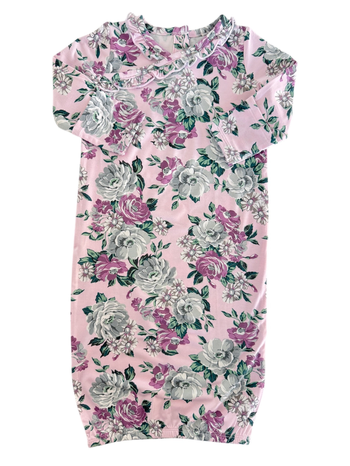 Floral dress in pink, featuring roses and greenery, with a ruffled neckline and short sleeves.