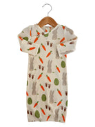 Cute baby sleeper with bunny and carrot print, hanging on a wooden hanger against a white background.