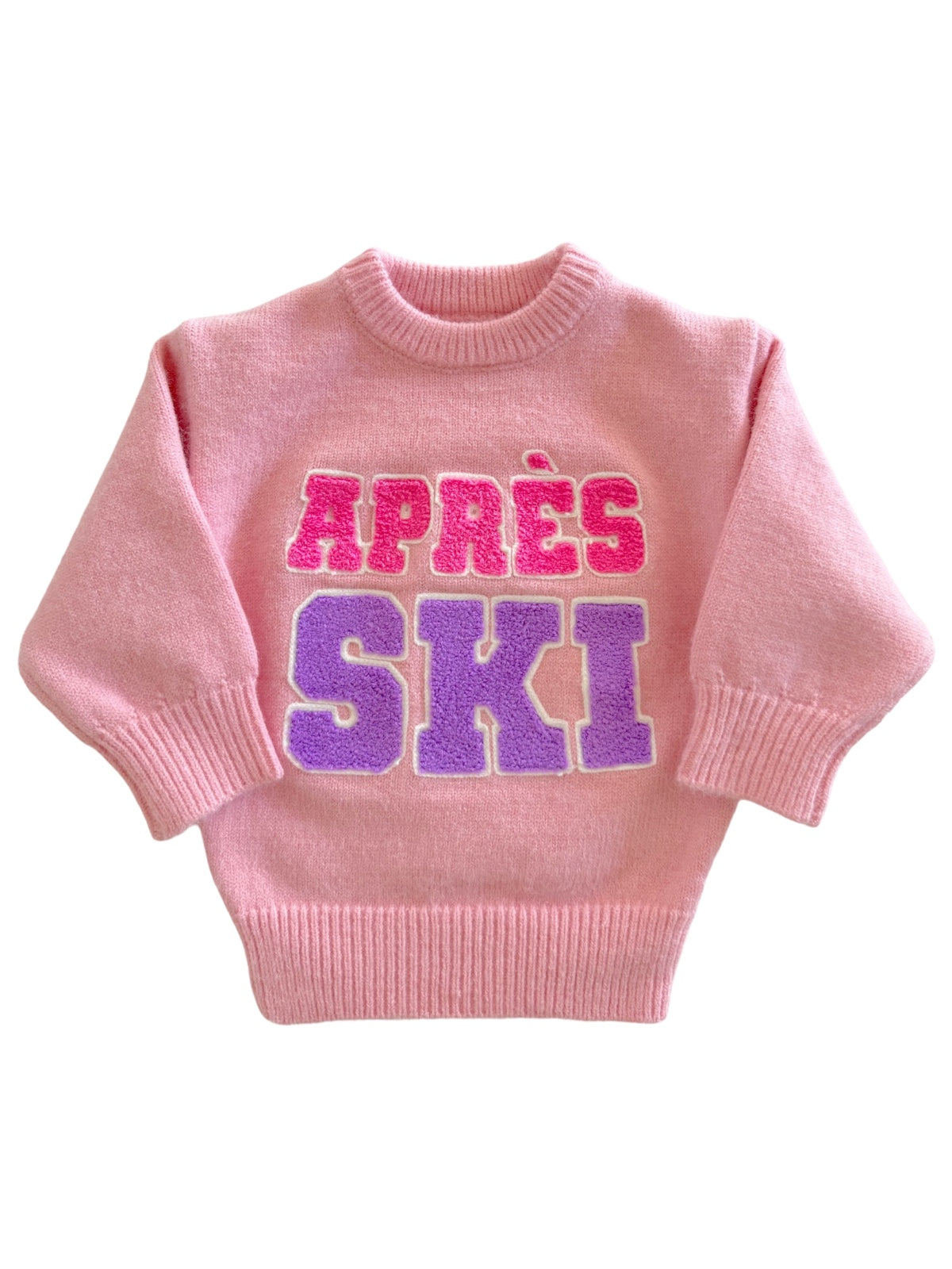 Pink sweater with "APRES SKI" in bold purple and pink letters, perfect for winter fashion.
