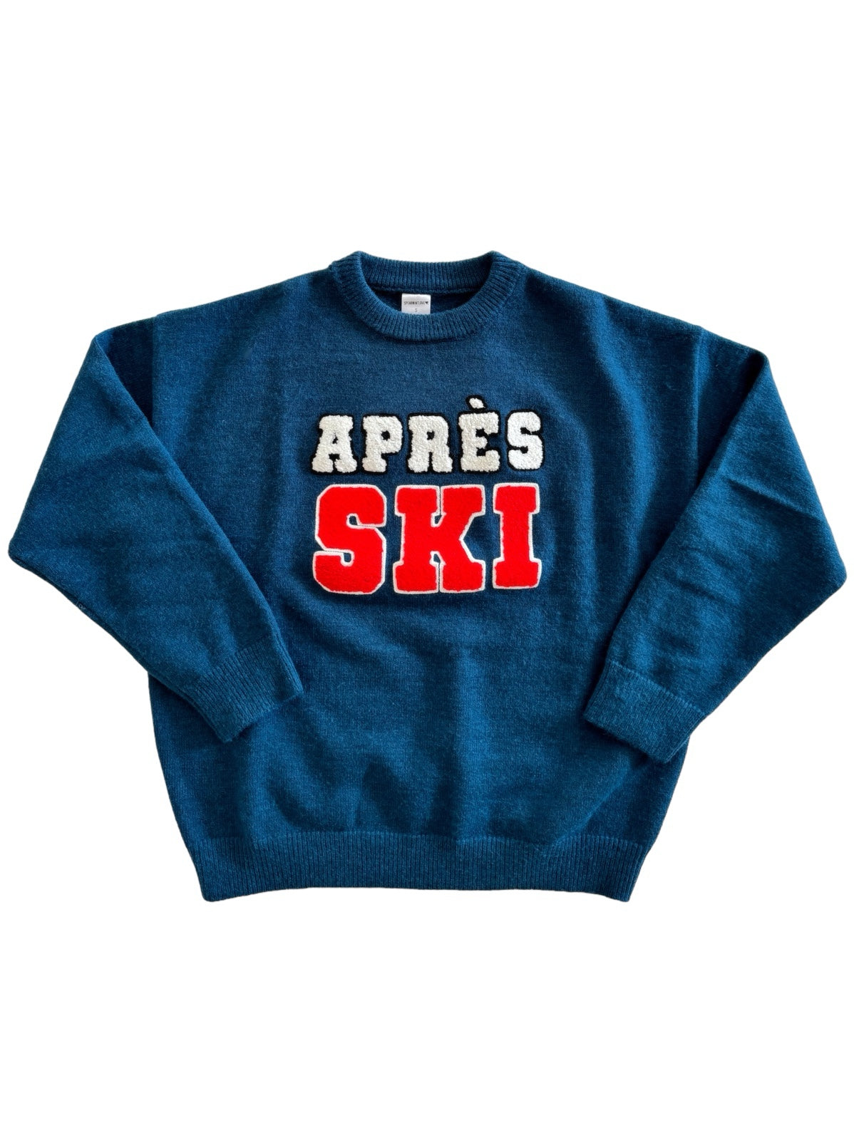 Blue sweater featuring "APRÈS SKI" in white and red lettering. Perfect for winter activities or casual wear.