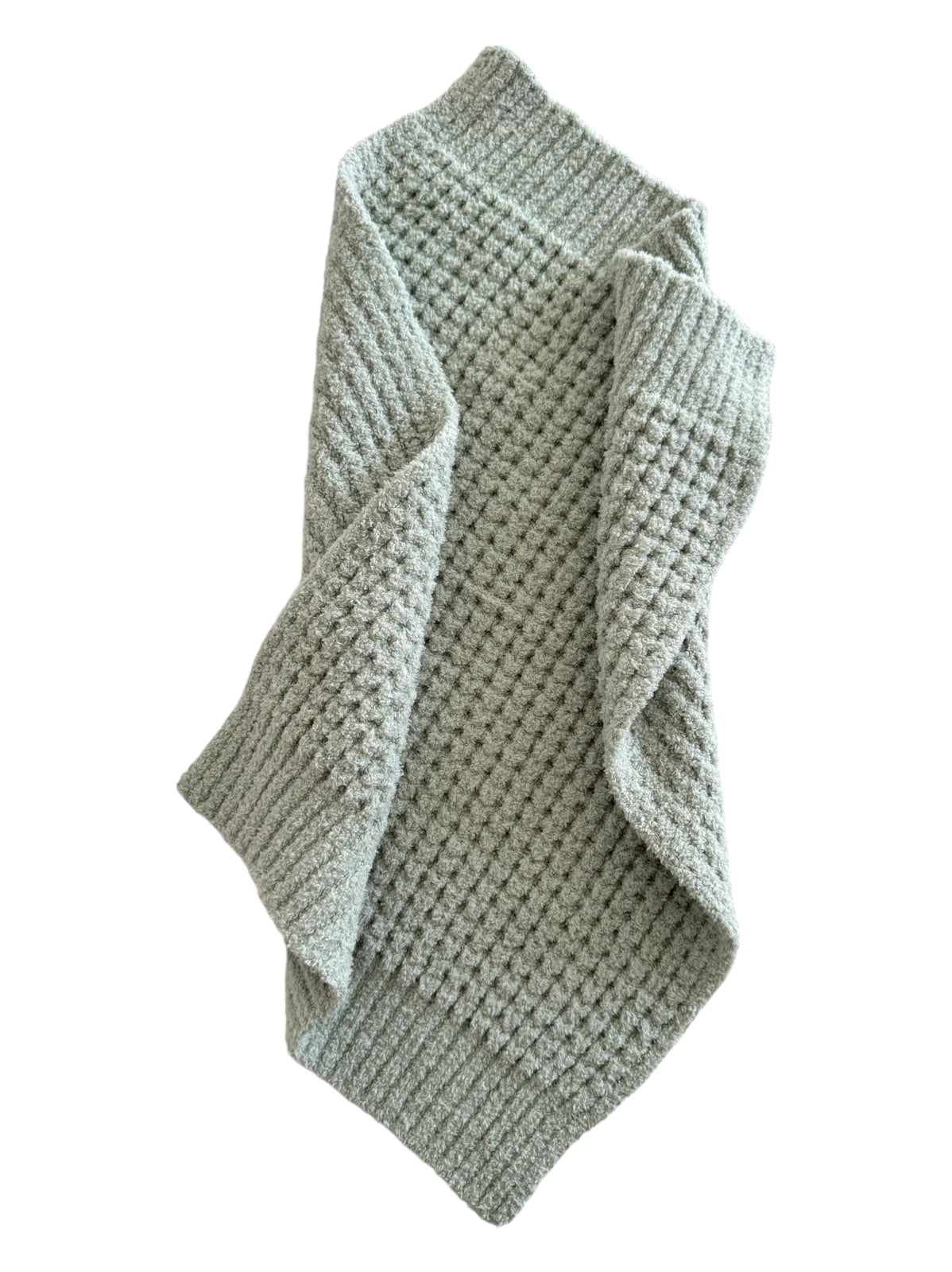 Textured light green blanket draped elegantly, showcasing its soft, cozy fabric.