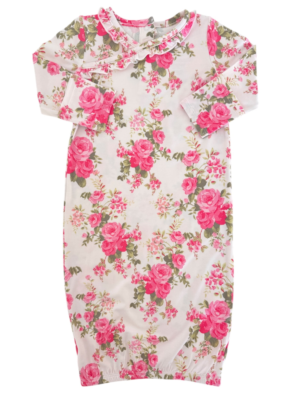 Floral dress featuring pink roses on a light background, with long sleeves and ruffled neckline.