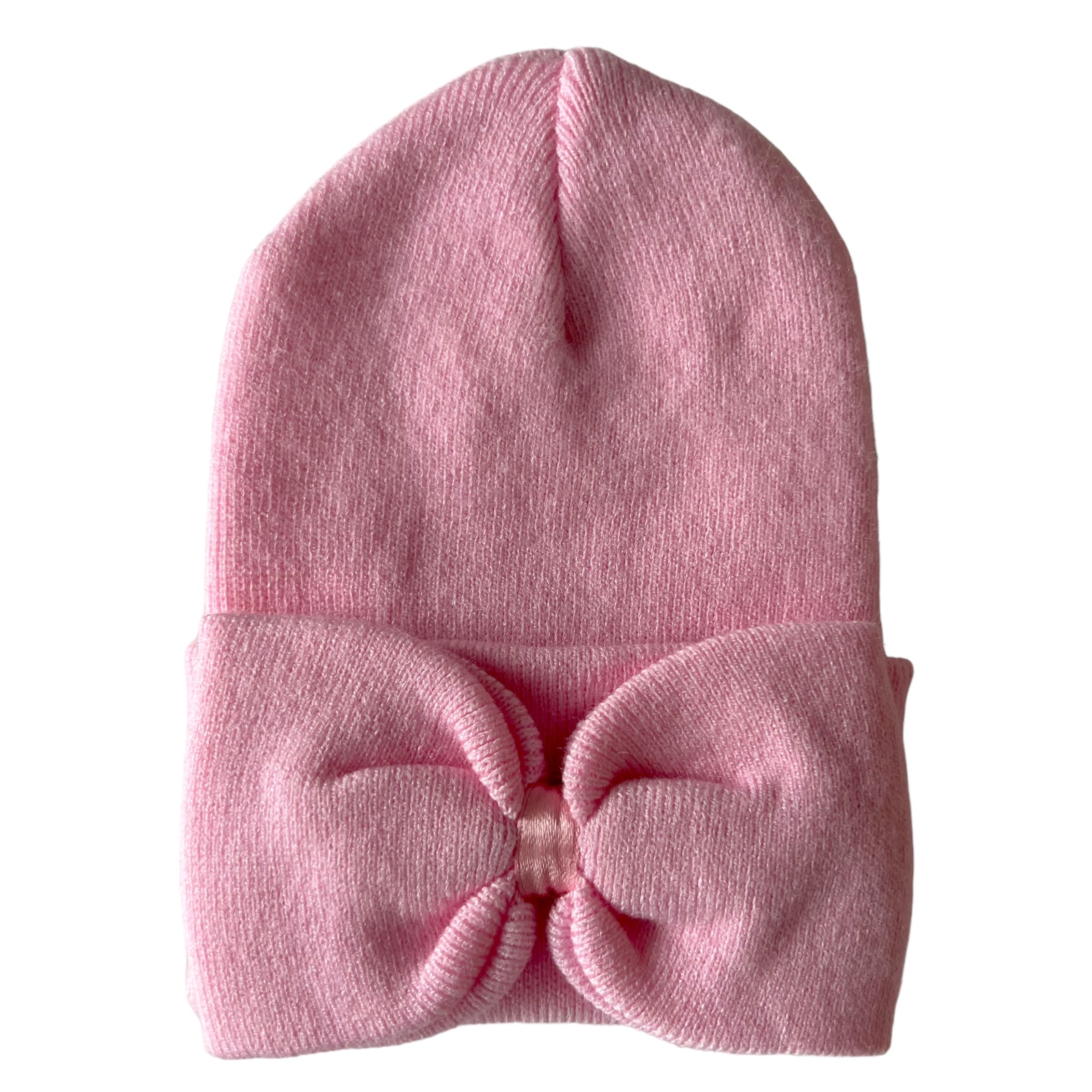Pink knit beanie with a large bow detail at the front, folded cuff at the bottom. Suitable for kids or fashion.