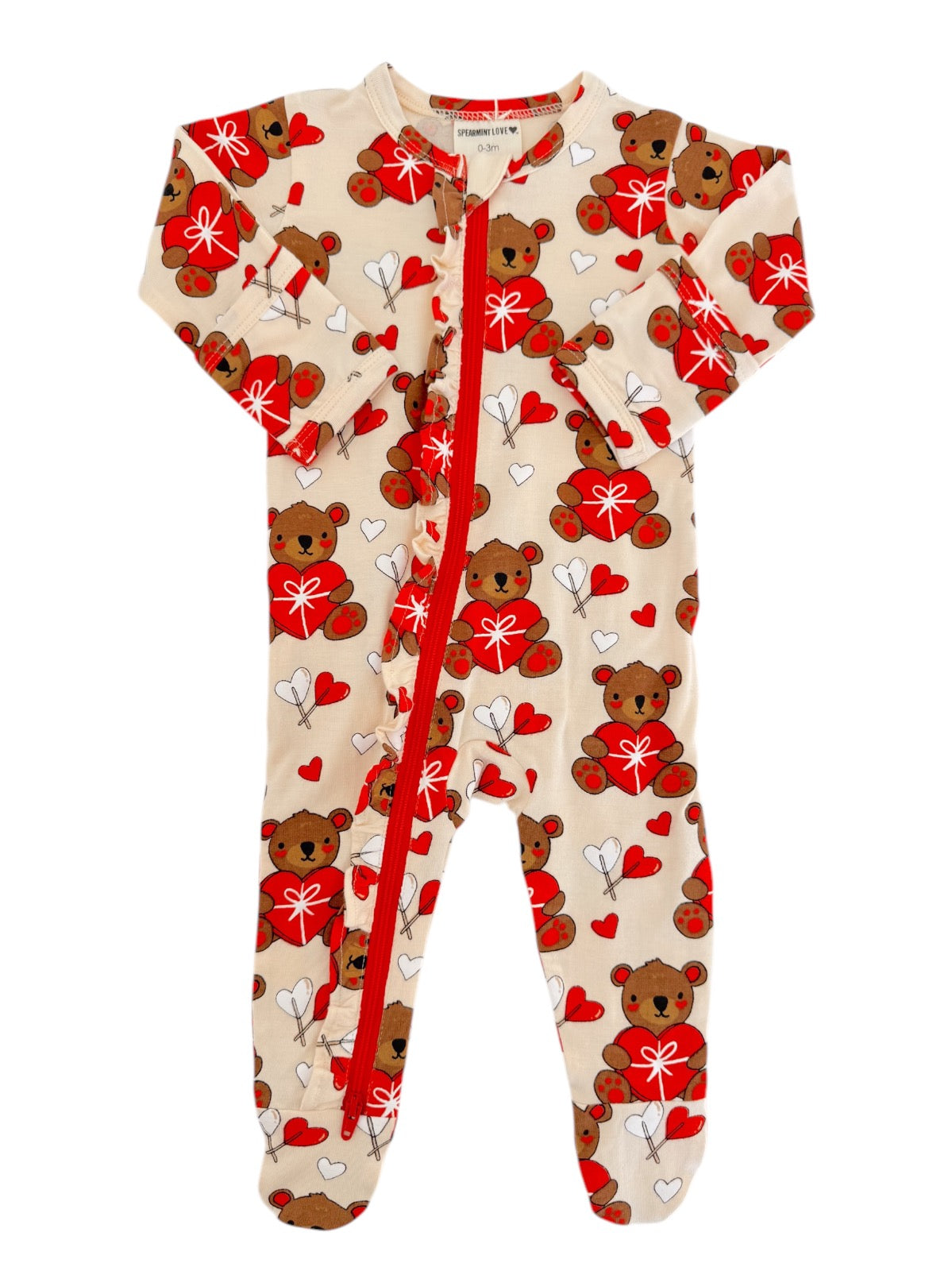 Beige baby onesie with teddy bears and hearts, featuring a front zipper and long sleeves. Ideal for infants.