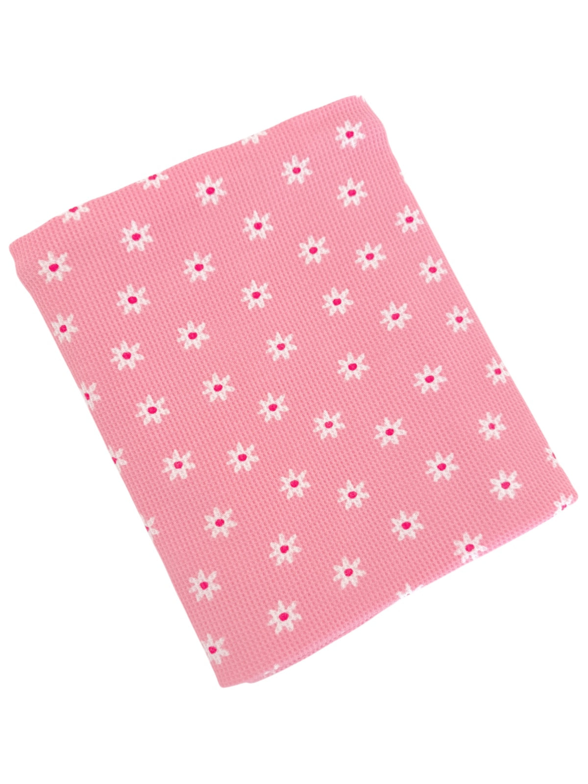 Pink fabric with a textured pattern featuring small white flowers and pink centers sprinkled throughout.