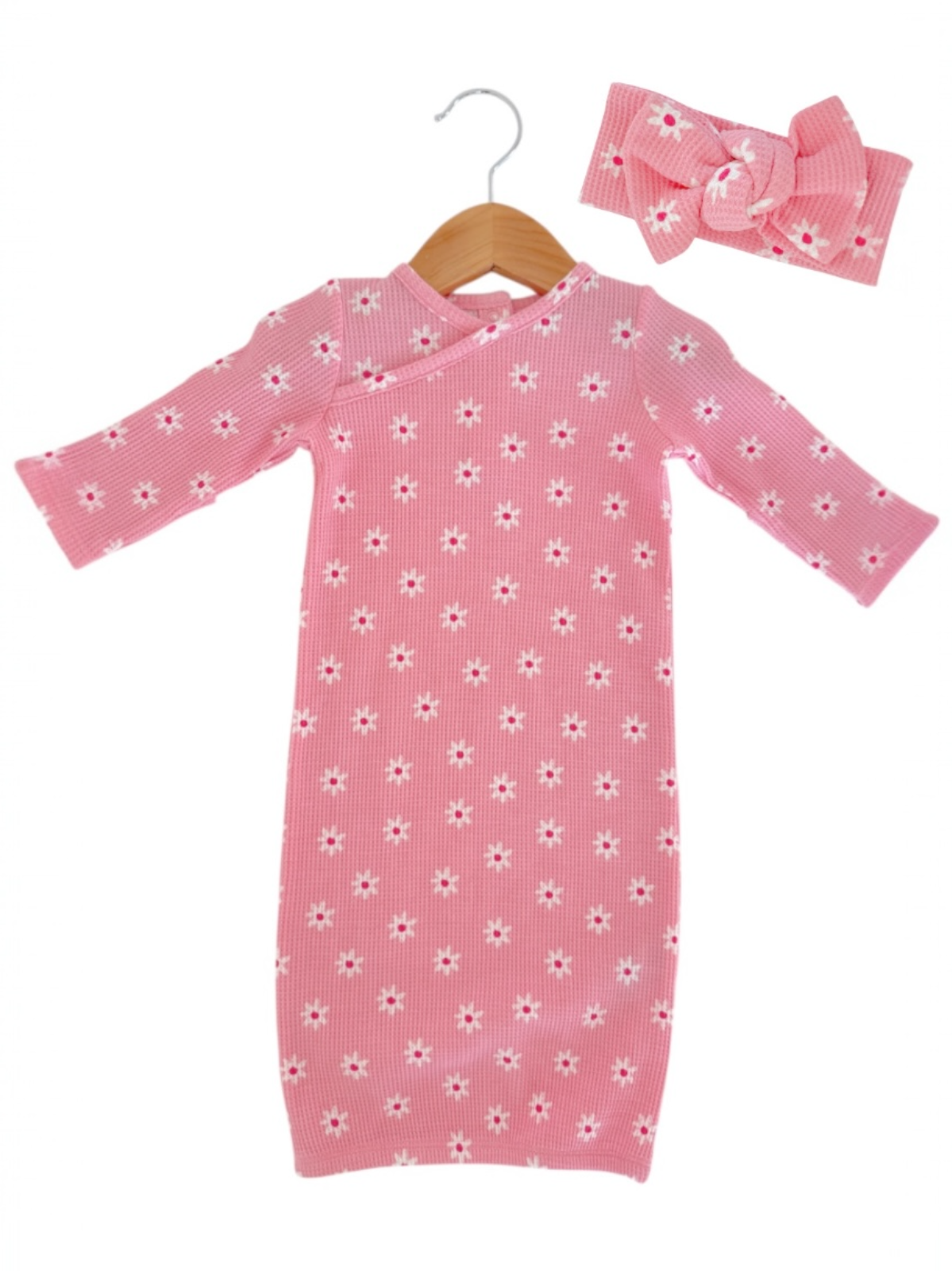 Pink floral dress with long sleeves and matching headband, designed for babies or toddlers.