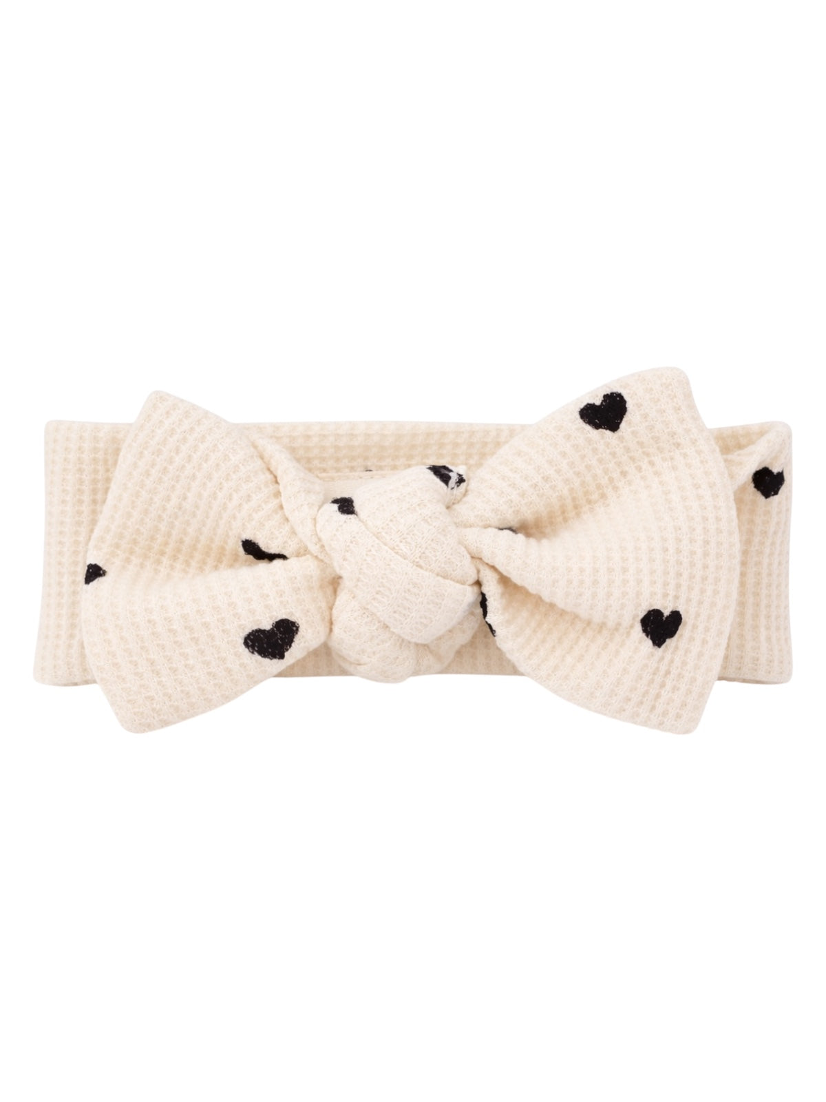 Cream headband with a knotted design and black heart patterns.