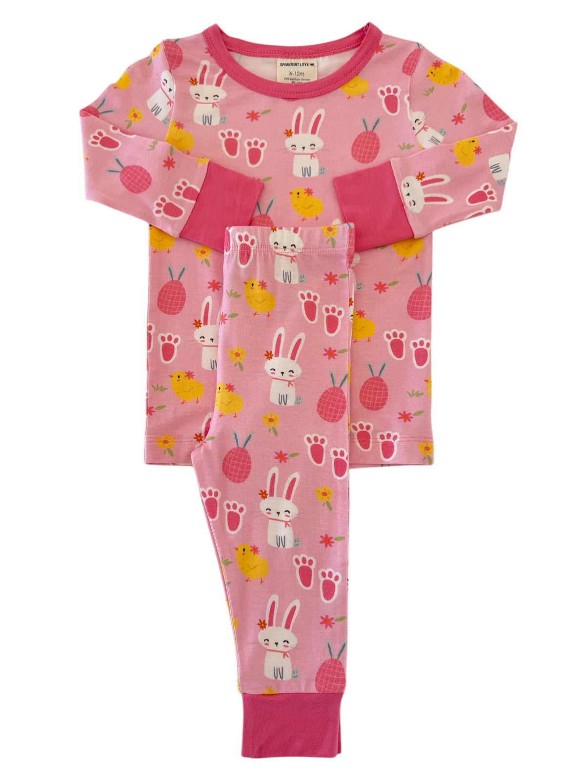 Pink children's pajamas featuring playful bunny and chick patterns with flowers and paw prints.