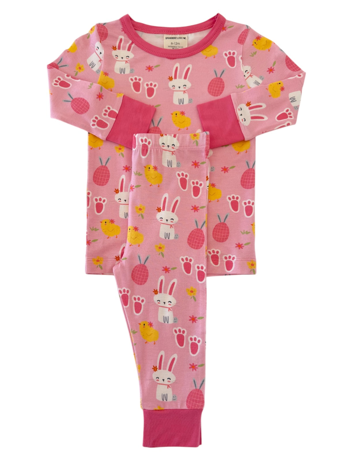 Pink children's pajamas featuring playful bunny and chick patterns with flowers and paw prints.
