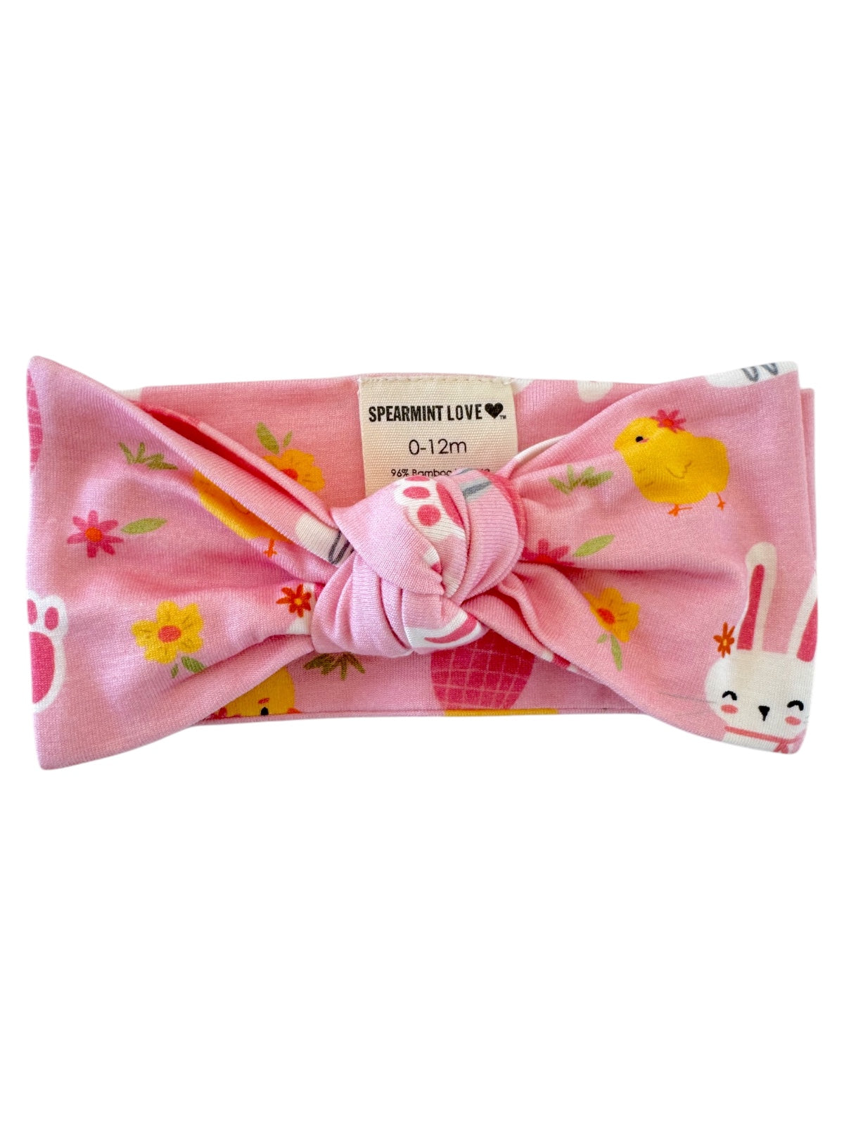 Pink baby headband with floral and animal patterns, featuring a large bow at the center. Ideal for ages 0-12 months.