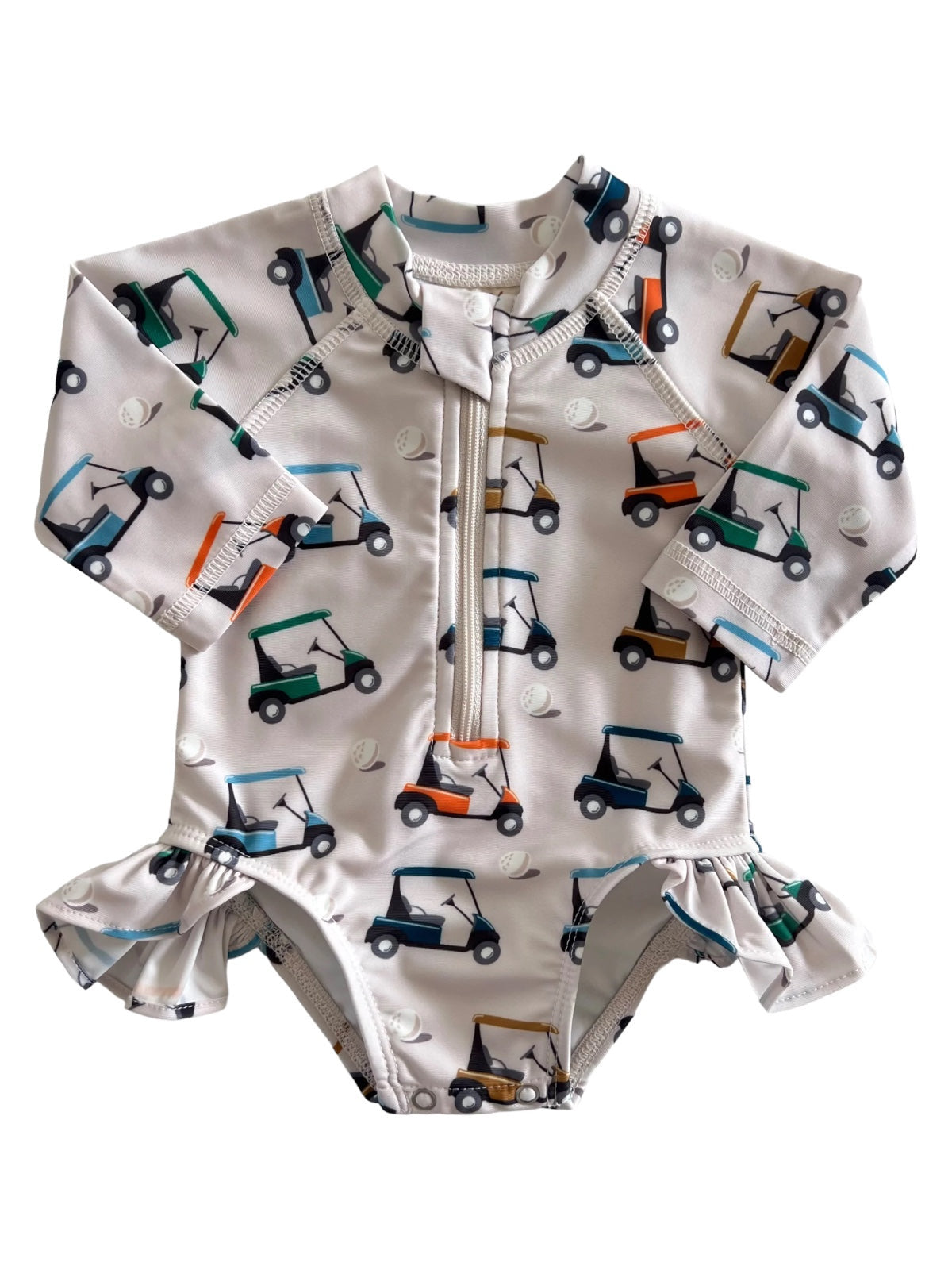 Children's rash guard swimsuit with golf cart print and ruffle detail, ideal for sun protection and beach fun.