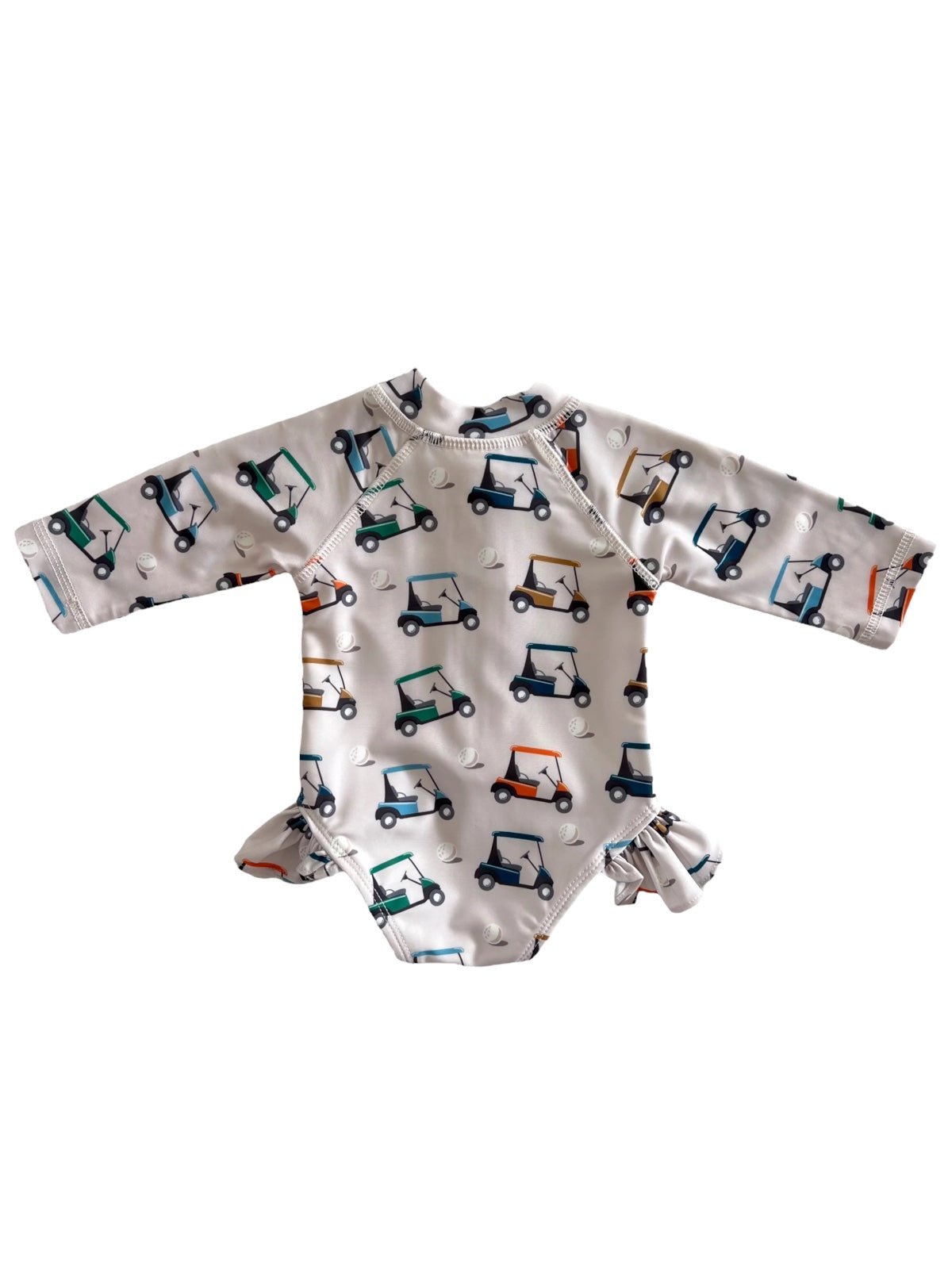 Child's long-sleeve swimsuit featuring colorful golf cart patterns on a white background.
