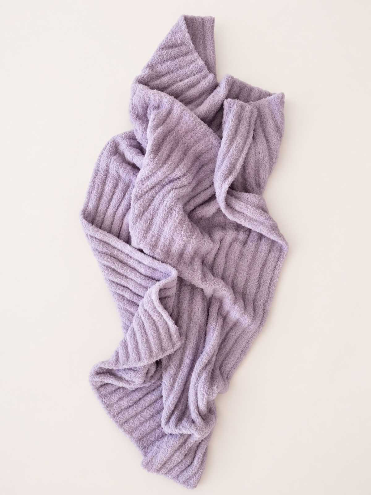 Lavender textured blanket draped on a light background, showcasing cozy design and softness.