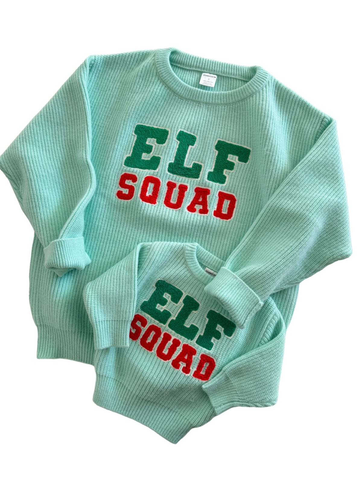 Matching mint green sweaters for kids and adults with "ELF SQUAD" in colorful letters.