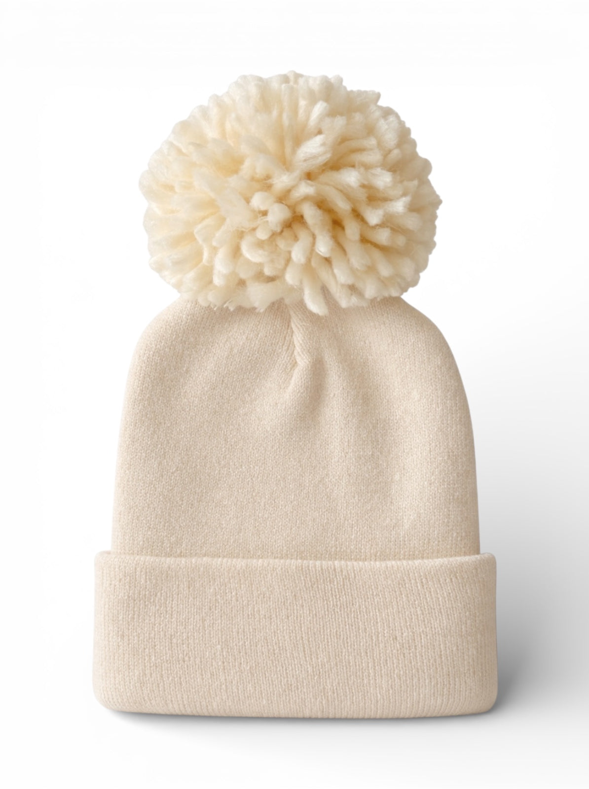 Cream-colored beanie hat with a fluffy pom-pom on top, perfect for winter wear.