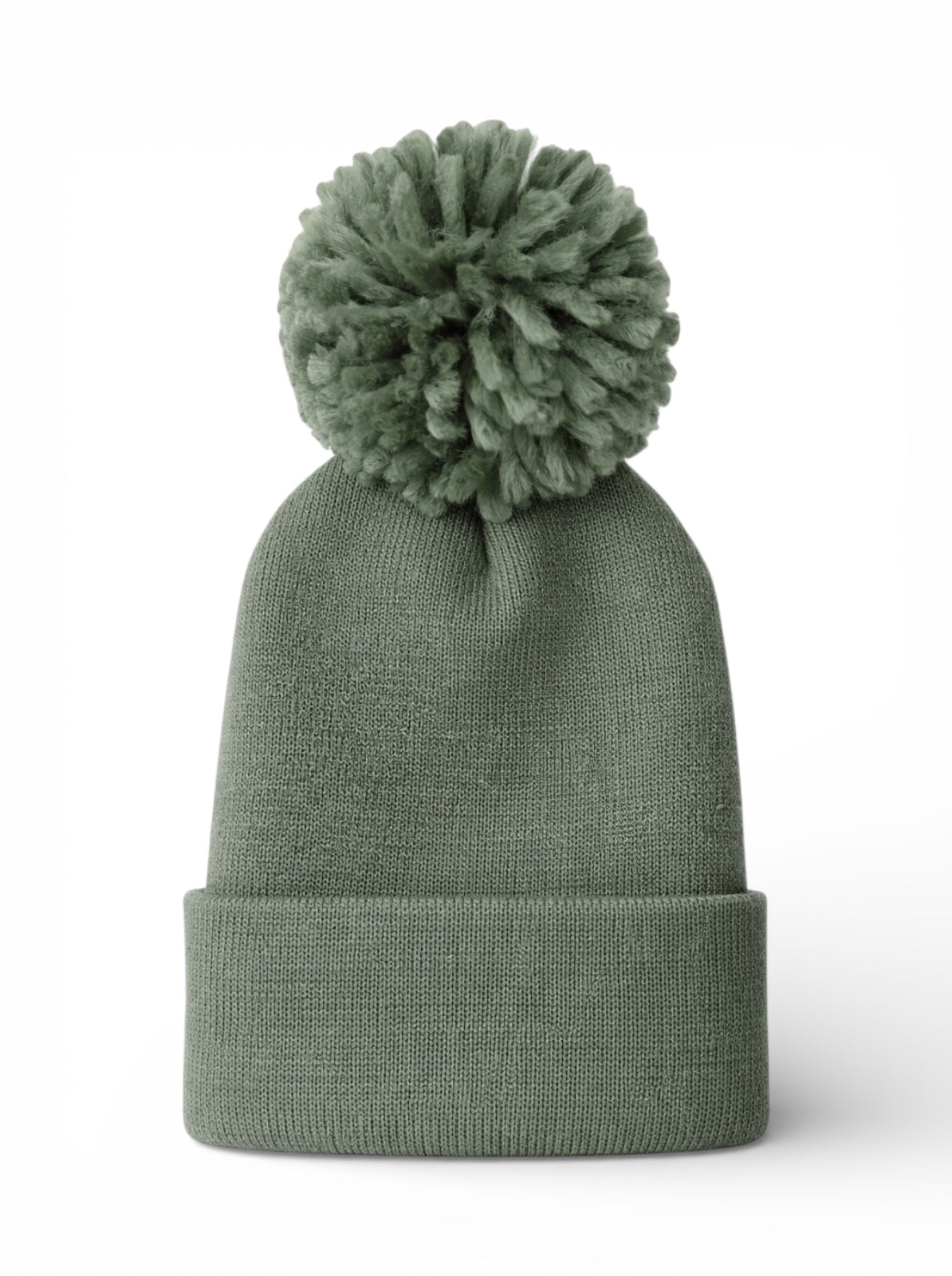 Green knit beanie with a fluffy pom-pom on top, set against a white background.