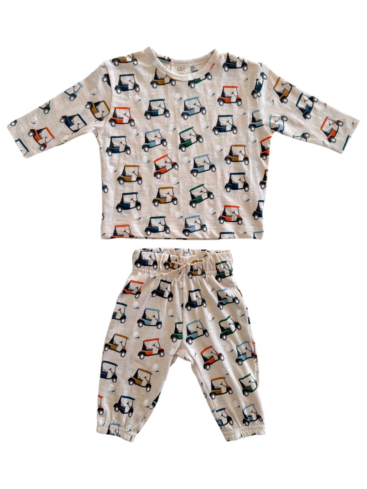Toddler outfit with golf cart print: long-sleeve top and pants set in light color. Ideal for casual play.