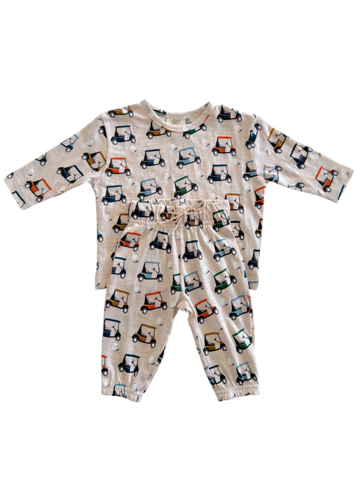 Children's two-piece outfit featuring a long-sleeve top and pants with colorful golf cart print on a beige background.