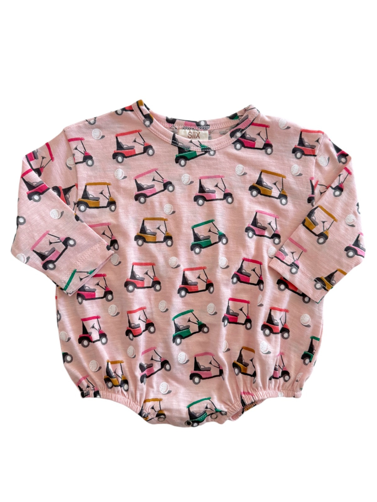 Pink long-sleeve shirt featuring colorful golf carts and golf balls pattern. Ideal for casual wear.