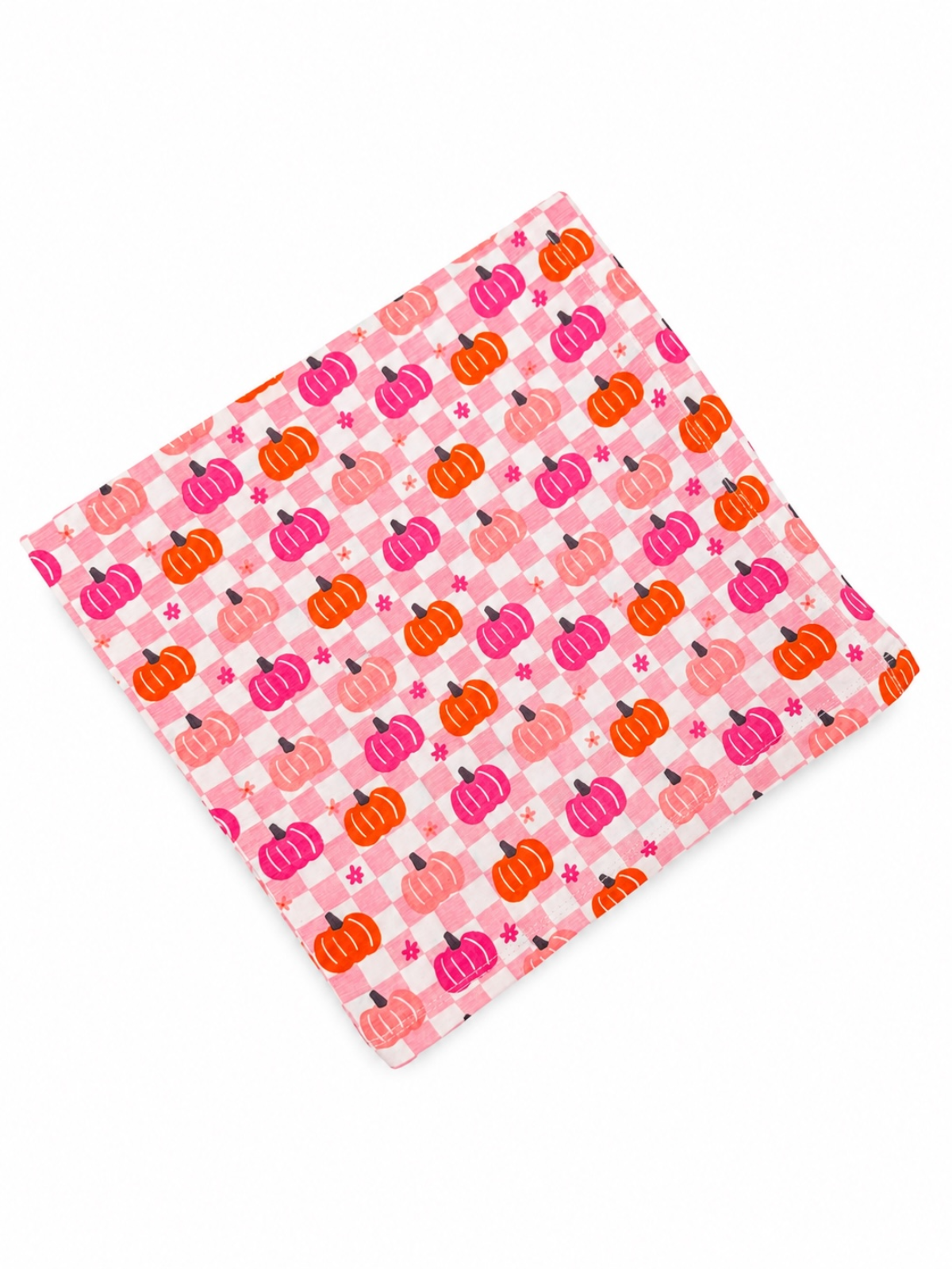 Colorful fabric featuring pink, orange, and purple pumpkins on a checkered background.