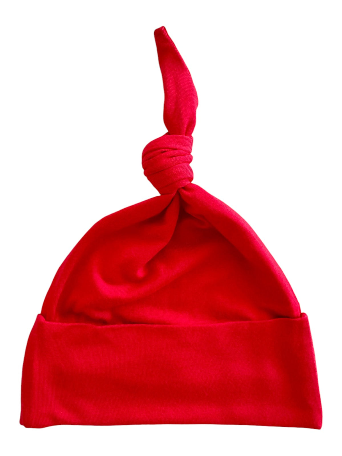 Red cotton beanie hat with a knotted top and a folded brim, ideal for stylish warmth.