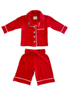 Red children's pajama set featuring a collared shirt and shorts with white piping details.
