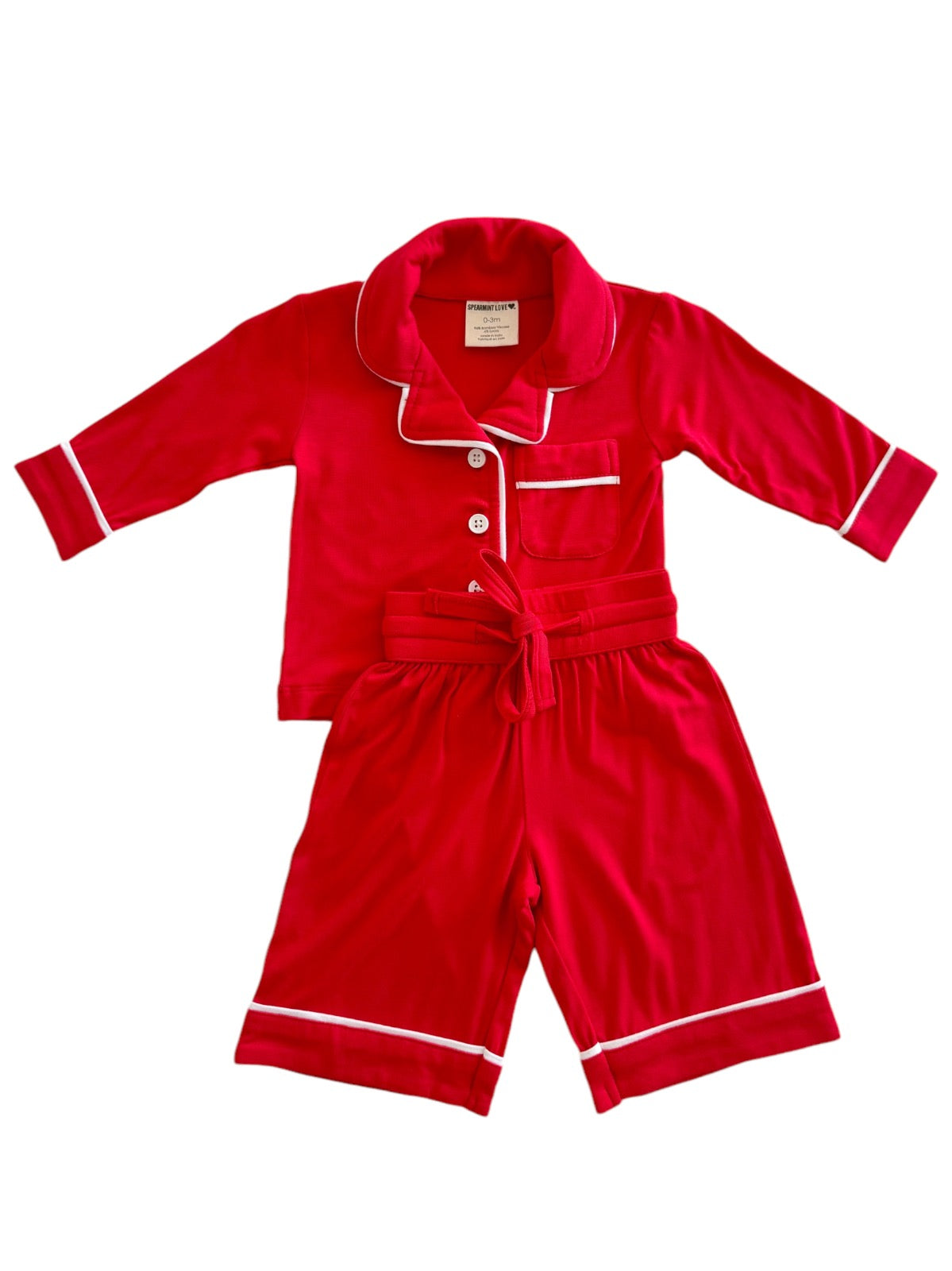 Red children's pajama set with white accents, featuring a button-up top and shorts. Ideal for cozy sleepwear.