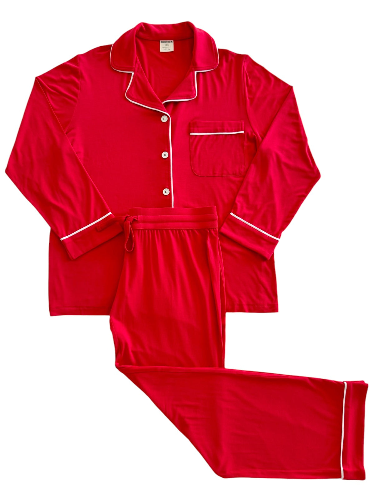 Red pajama set with long sleeves and pants, featuring white piping and a front pocket.