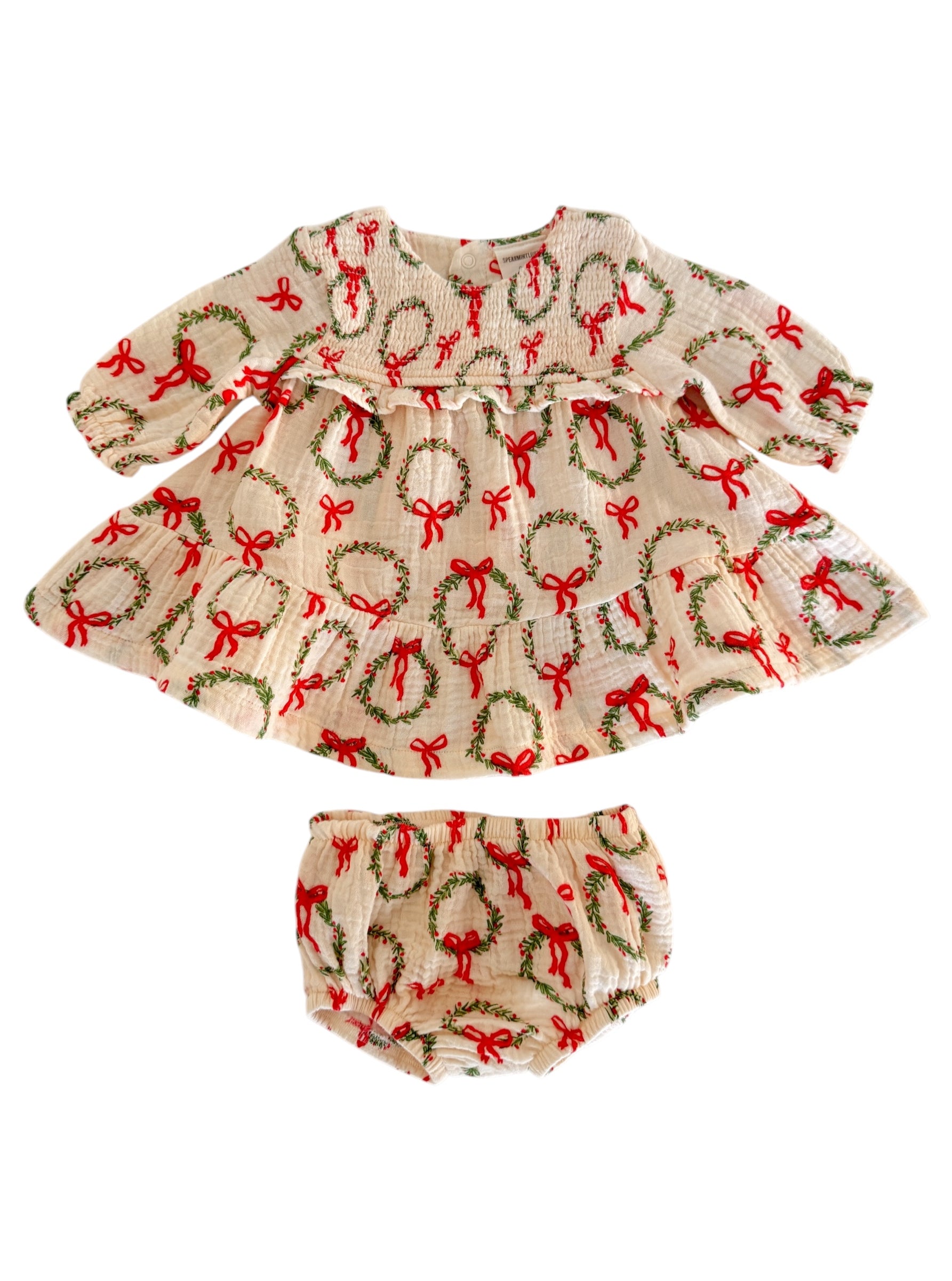 Cream dress with red bows and wreaths, paired with matching bloomers. Perfect for festive occasions.