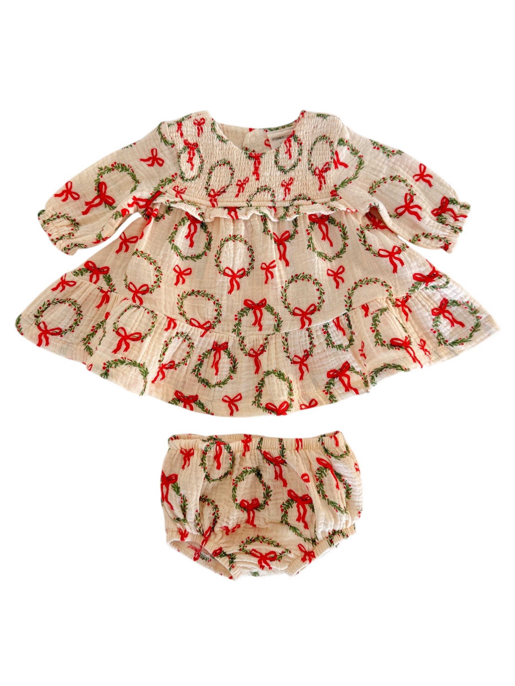 Cream dress with red bows and wreaths, paired with matching bloomers. Perfect for festive occasions.