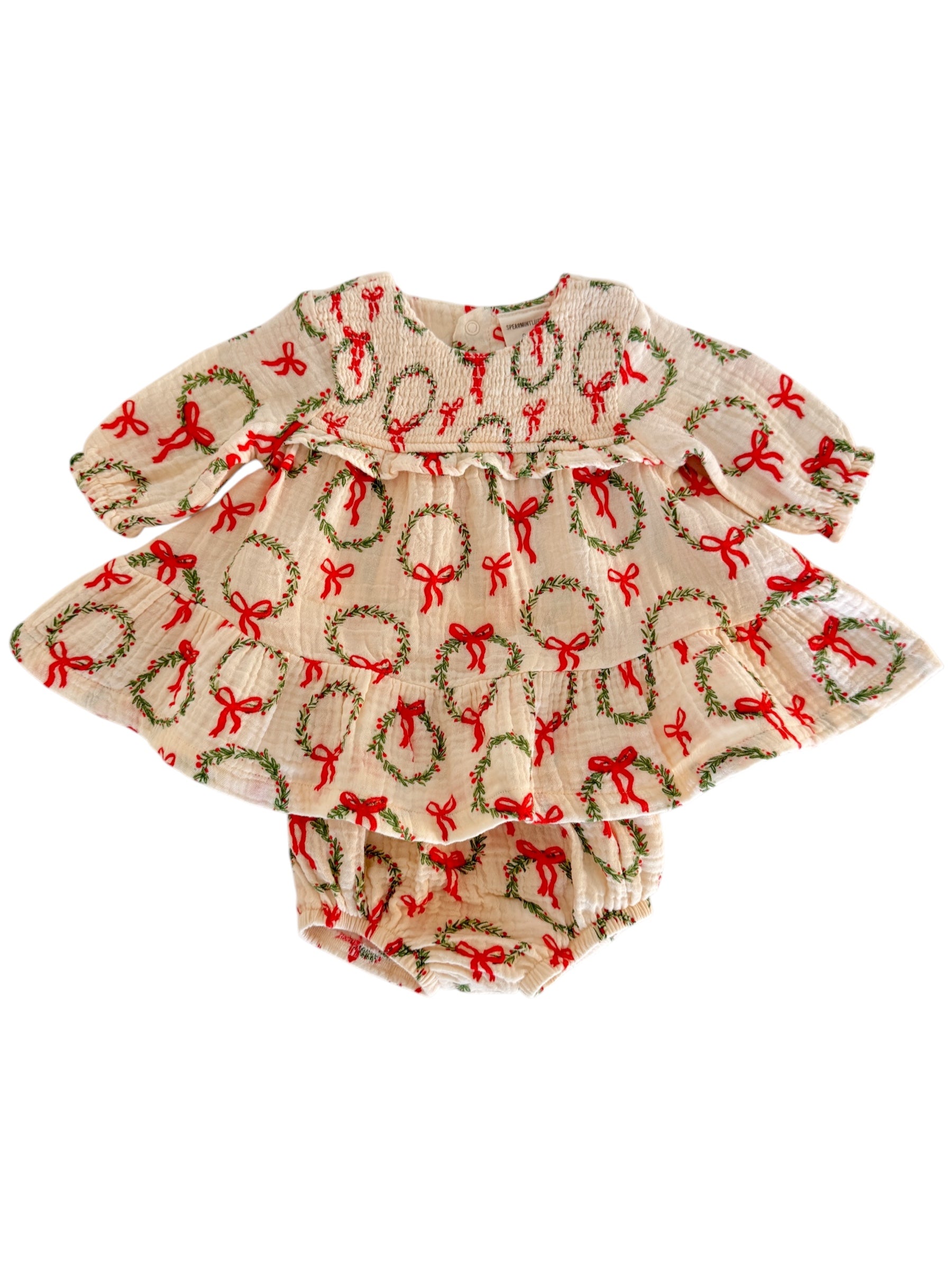 Baby dress with wreath and bow pattern, featuring long sleeves and ruffled skirt. Perfect for festive occasions.