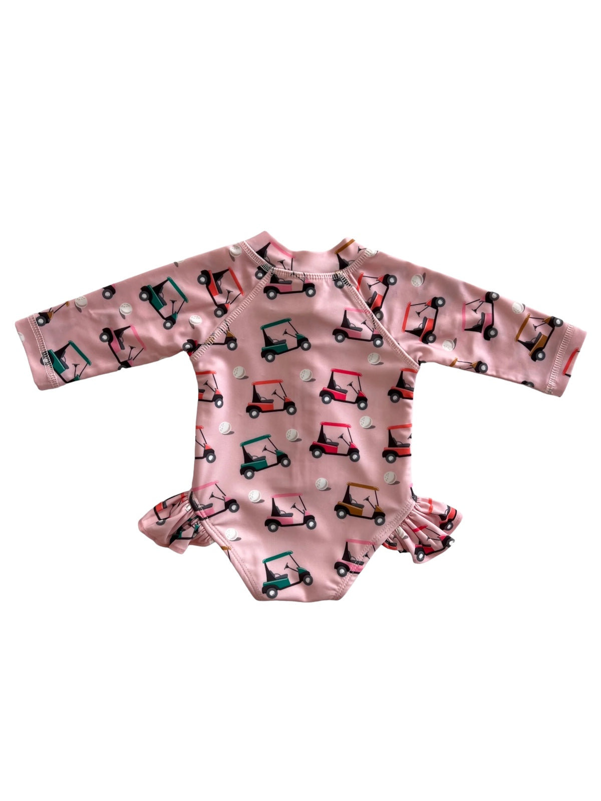 Pink long-sleeve swimsuit with a pattern of colorful golf carts and small golf balls.