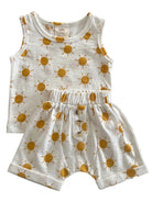 Toddler outfit featuring a sleeveless top and shorts with a yellow sun pattern on a white background.