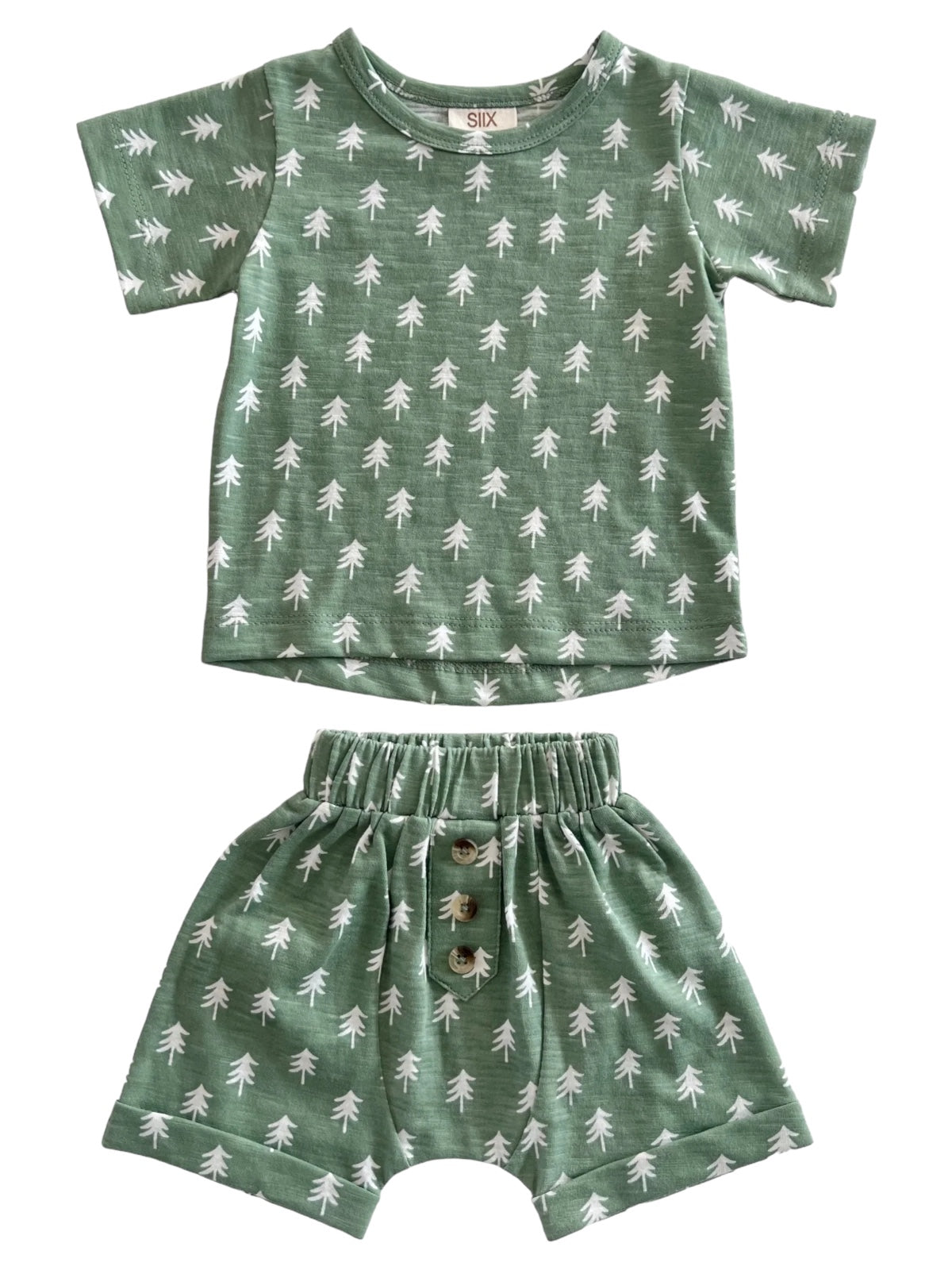 Green children's outfit consisting of a short-sleeve shirt and matching shorts with white tree patterns.