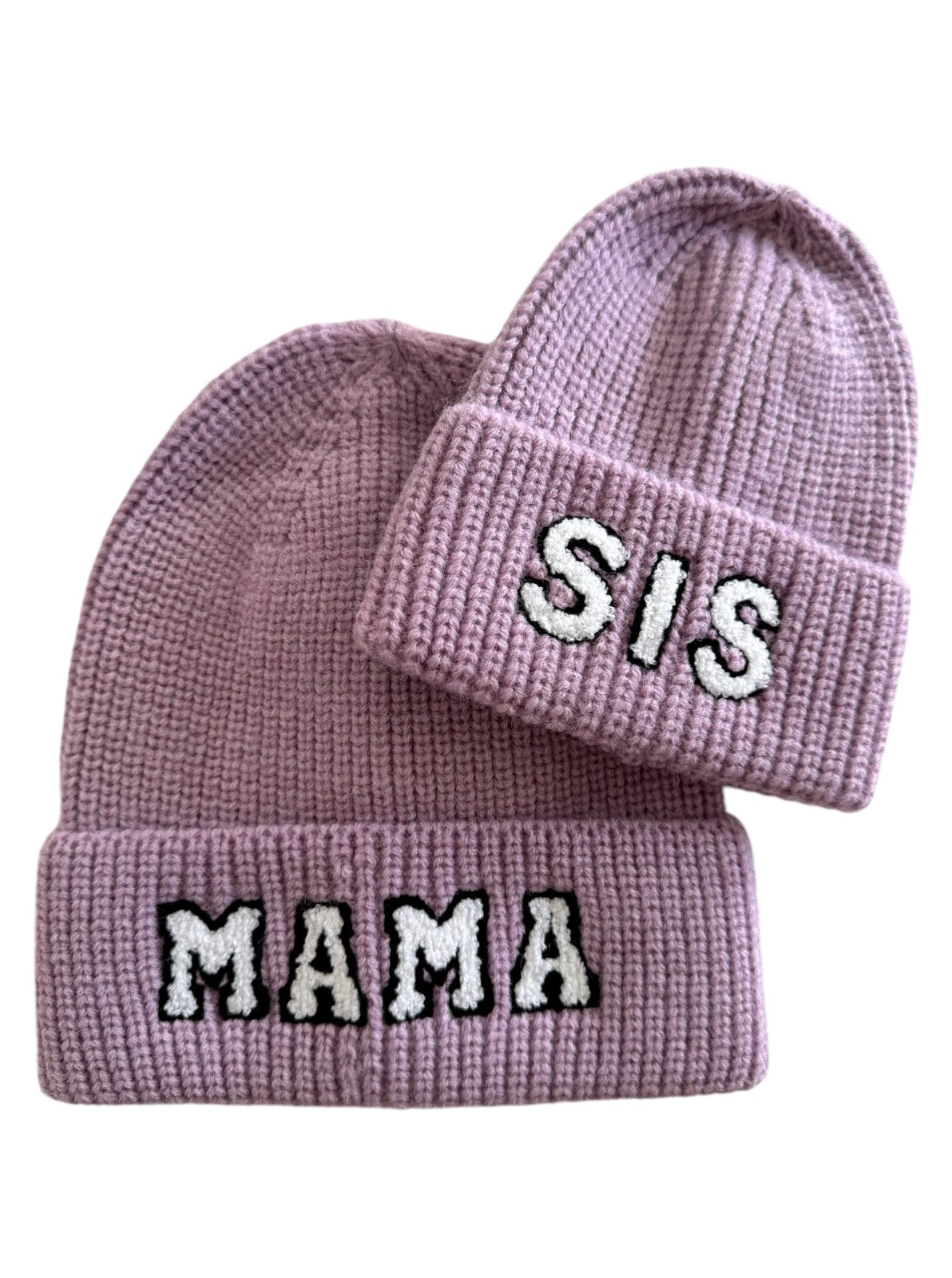 Two lavender beanies with embroidered text: one reading "MAMA" and the other "SIS."