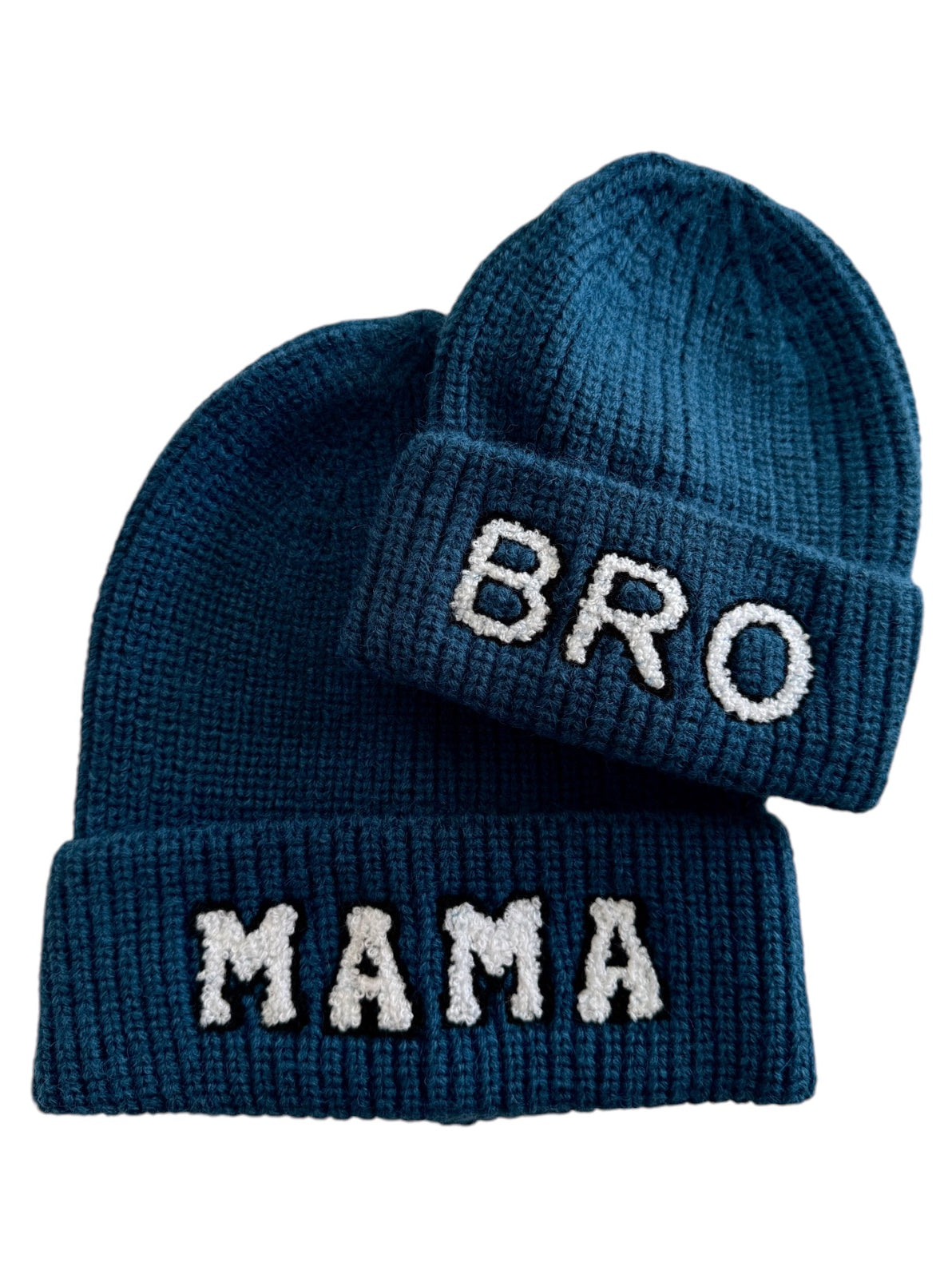 Two knitted beanies in dark blue, one labeled "BRO" and the other "MAMA."
