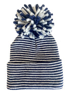 Striped beanie hat with a large pom-pom on top, featuring navy blue and white colors.