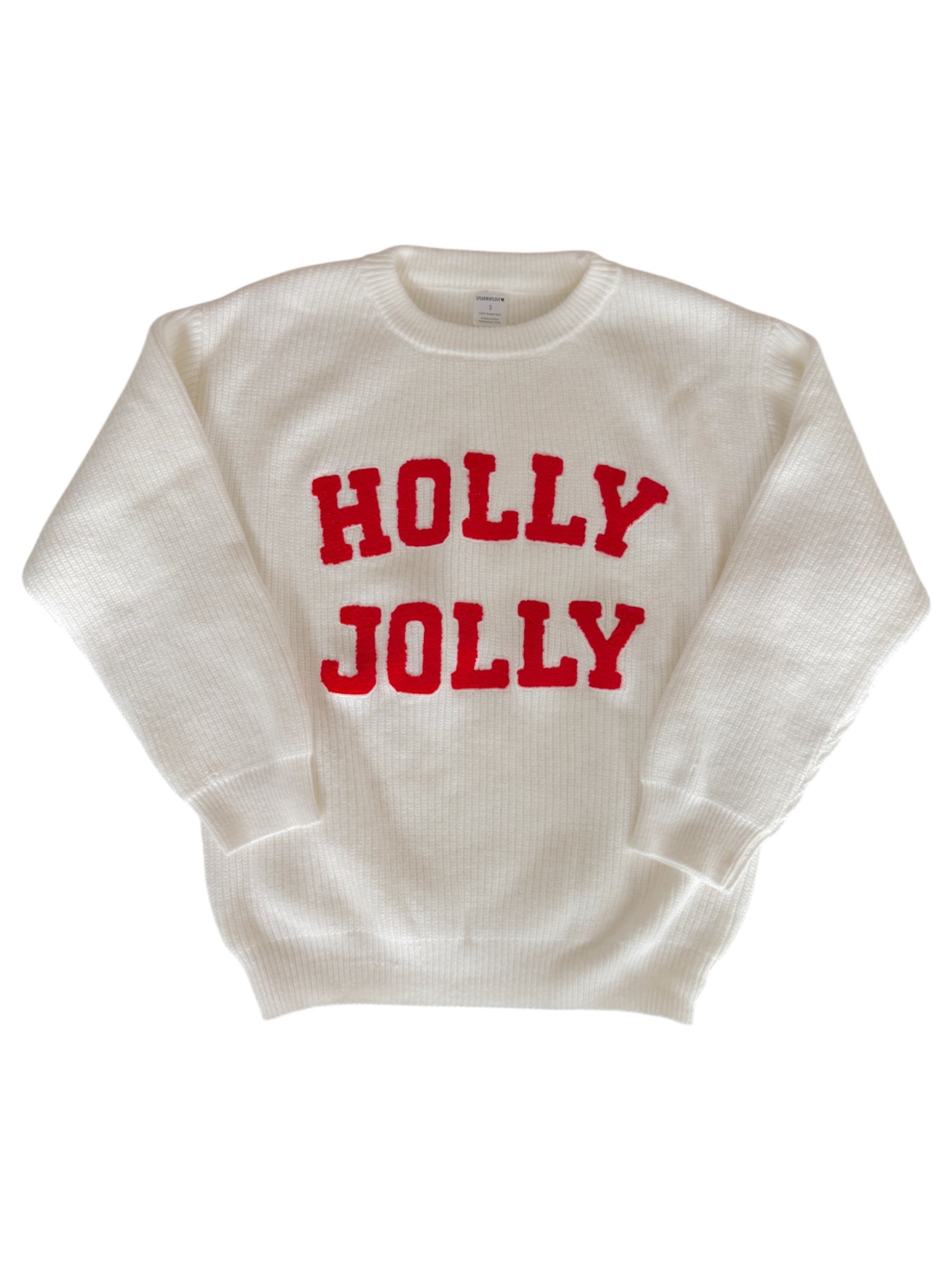 White sweater with "HOLLY JOLLY" in bold red letters across the front.
