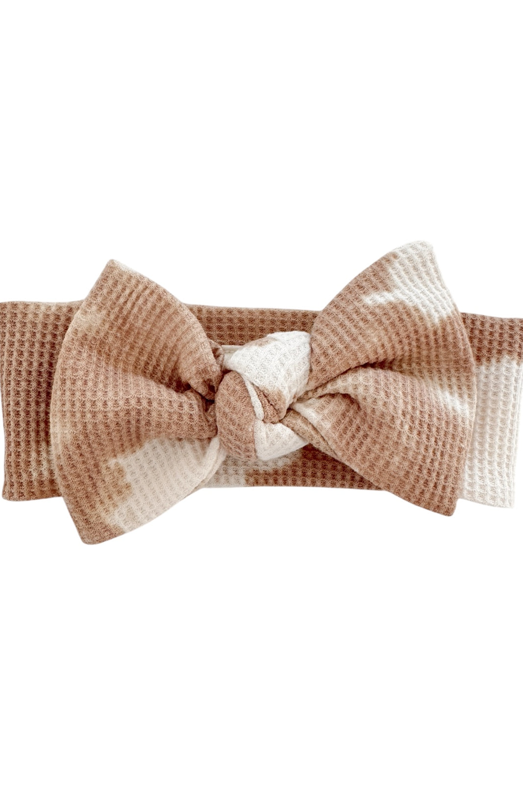 Brown and white patterned headband with a large bow design, made of soft textured fabric.