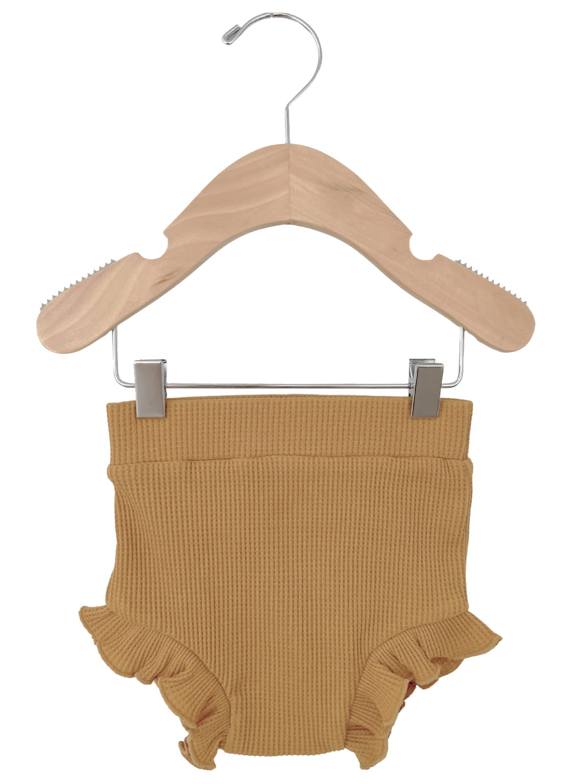 Tan toddler diaper cover with ruffle details, hanging on a wooden clothes hanger.