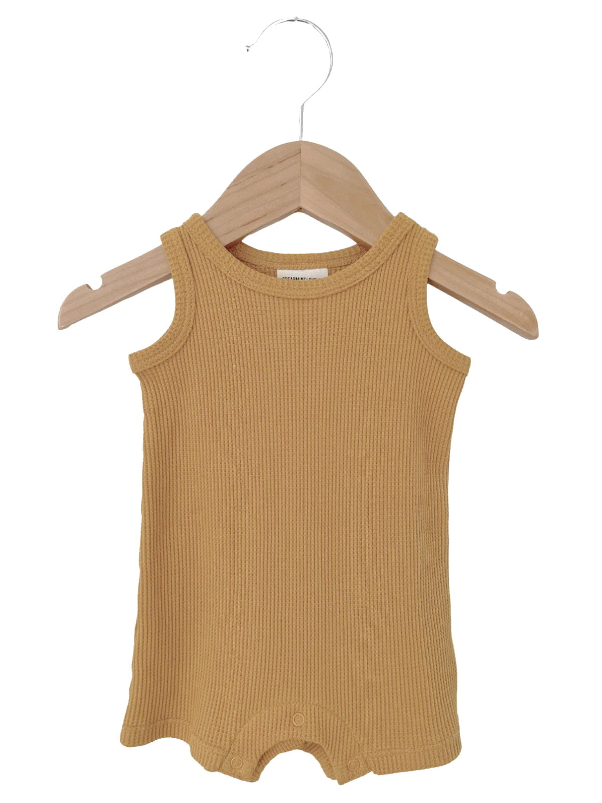 Mustard yellow ribbed tank onesie hanging on a wooden hanger.