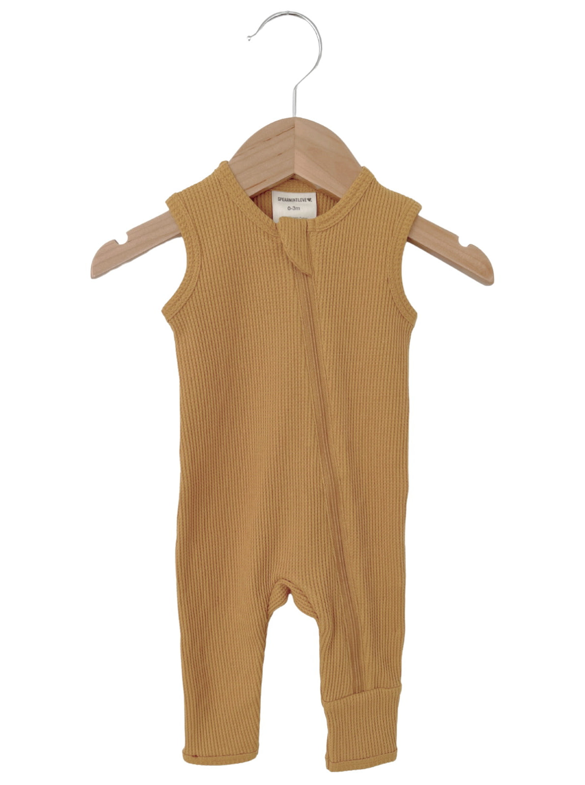 Mustard-colored infant onesie on a wooden hanger, featuring a zipper and ribbed texture. Ideal for ages 0-3 months.