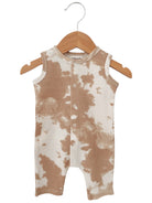 Tan and white tie-dye toddler romper hanging on a wooden hanger.